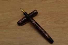 A Parker Televisor slender button fill fountain pen in Red lined with three narrow cap bands