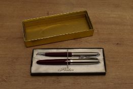 A boxed Parker 21 aerometric fill fountain pen and pencil in Red with stainless steel cap. Circa