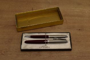 A boxed Parker 21 aerometric fill fountain pen and pencil in Red with stainless steel cap. Circa