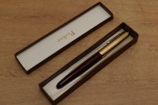 A boxed Parker 51 aerometric fill fountain pen in Burgundy with Gold fill converging line cap. Circa