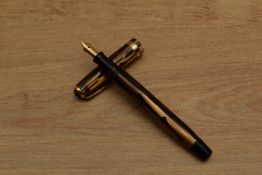 A Parker Duofold Geometric (Toothbrush) button fill fountain pen in Gold and Black with broad cap