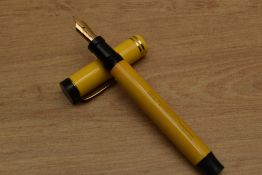 A Parker Duofold Senior Lucky Curve button fill fountain pen in Mandarin Yellow with two narrow