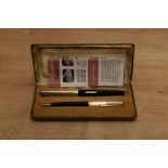 A boxed Parker 51 aerometric fill fountain pen and pencil set in Black with God fill with converging
