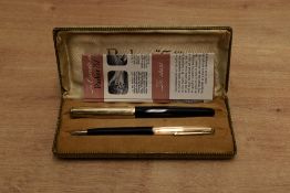 A boxed Parker 51 aerometric fill fountain pen and pencil set in Black with God fill with converging