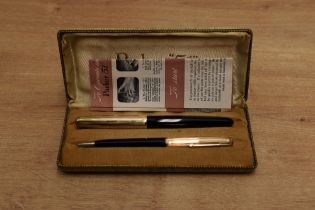 A boxed Parker 51 aerometric fill fountain pen and pencil set in Black with God fill with converging