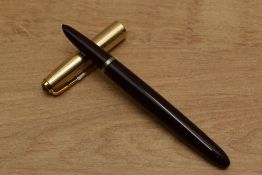 A Parker 51 aerometric fill fountain pen in Burgundy with Gold Fill converging line cap. Circa 1950