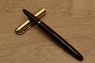A Parker 51 aerometric fill fountain pen in Burgundy with Gold Fill converging line cap. Circa 1950