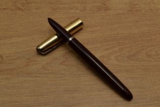 A Parker 51 vacumatic fill fountain pen in Cordovan Brown with Gold fill converging line cap.