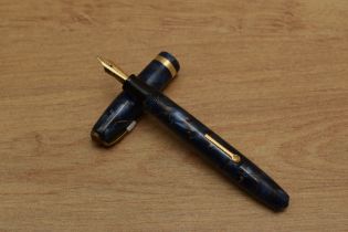 A Conway Stewart 84 lever fill fountain pen in Blue Marble with gold veins with single broad cap