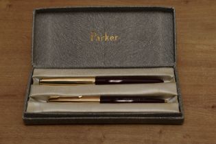 A boxed Parker 51 aerometric fill fountain pen and ballpoint pencil in Burgundy with Rolled Gold