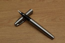 A Sheaffer Triumph 444 converter fill fountain pen in Stainless Steel having Sheaffer nib. Circa