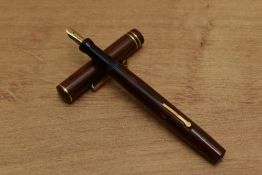 A Wahl lever fill fountain pen in Red and Black woodgrain with two narrow cap bands having a Wahl
