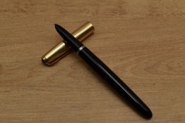 A Parker 51 aerometric fill fountain pen in Black with Rolled Gold converging line cap. Circa 1953
