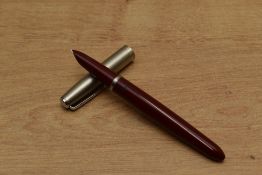 A Parker 21 Standard MkI aerometric fill fountain pen in Red with brushed steel cap. Circa 1949. A