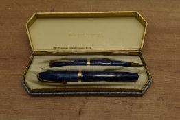 A boxed Conway Stewart No84 lever fill fountain pen and No26 Pencil in Blue Cracked Ice with Gold