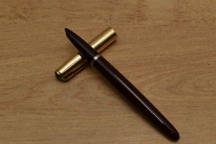 A Parker 51 vacumatic fill fountain pen in Cordovan Brown with Gold fill converging line cap.