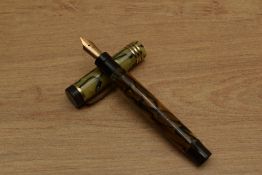 A Parker Duofold Junior button fill fountain pen in Black and Pearl with three bands to a Flat Top
