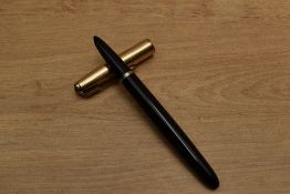 A Parker 51 Aerometric fill fountain pen in Black with gold filled parallel lined cap. Circa 1954