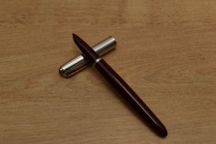 A Parker 51 aerometric fill in Burgundy with Rolled Silver converging line cap with gold clip. Circa