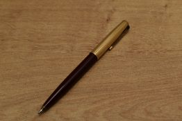 A Parker 51 ballpoint pen in Burgundy with Rolled Gold converging lines cap. Circa 1955