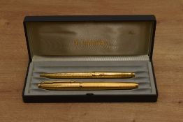 A boxed Parker 75 converter fill fountain pen and ballpoint pen set in Verdome Grain d'Orge gold