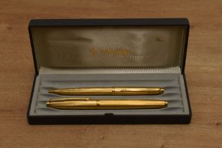 A boxed Parker 75 converter fill fountain pen and ballpoint pen set in Verdome Grain d'Orge gold