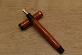 A Parker Duofold Senior Lucky Curve button fill fountain pen in Red with single cap band having