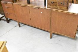 A vintage teak sideboard , having cutlery drawer and two further drawers, double cupboard and drop