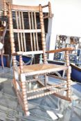 A 19th Century oak knitting chair having rush seat