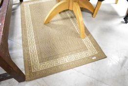A modern nylon rug, in greek key design, approx. 147 x 81cm
