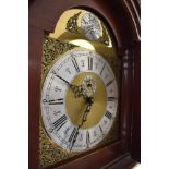 An early to mid 20th Century mahogany and walnut long case clock having brass and silvered dial