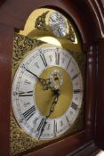 An early to mid 20th Century mahogany and walnut long case clock having brass and silvered dial