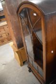 An early 20th Century oak china cabinet having arch top (one pane of glass missing) height approx.