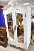 A traditional painted Mahogany armoire wardrobe having wooden