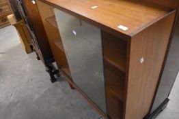 A vintage teak bookcase, raised on circular tapered legs, dimensions approx. height 100 width 92