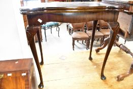 An early 20th Century fold over tea table having shaped top and cabriole legs, width approx. 76cm