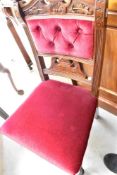 A set of seven late Victorian mahogany dining chairs having overstuffed seats and button backs