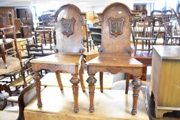 A fine pair of 19th Century oak hall chairs, having monogram to back applique cartouche , possibly