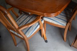 A nice quality modern yew effect extending dining table and set of six (four plus two) similar