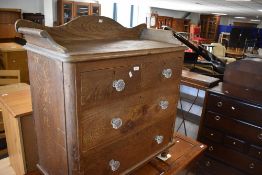 A Victorian scumbled pine chest of two over two chest of drawers having ledge back and glass