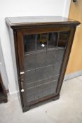 An early 20th Century oak display cabinet/bookcase having leaded glass door, dimensions approx.