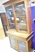 A 19th Century oak bookcase having glazed upper and lower sections , central drawer with lock