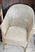 A vintage Lloyd Loom tub chair, in gold finish