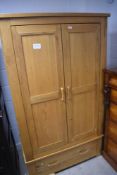 A modern golden oak double wardrobe having drawer base, dimensions approx. height 192 width 111