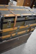 A traditional pine tool or bedding chest and a vintage travel trunk