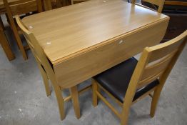 A modern beech laminate drop leaf kitchen table and four chairs