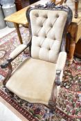 A Victorian mahogany scroll armchair , having button back dralon upholstery