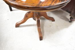 A modern hardwood coffee table having circular top, diameter approx. 74cm