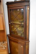 An Edwardian mahogany corner cabinet having astral glazed top over cupboard base, with inlaid