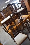 A set of six reproduction mahogany dining chairs having upholstered drop in seats